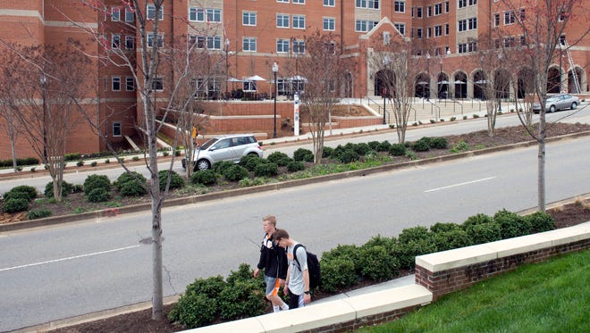 Students walk past University of Tennessee's Stokely Family Residence Hall on Monday, March 27, 2017 where the Title IX Commission held a “listening session."