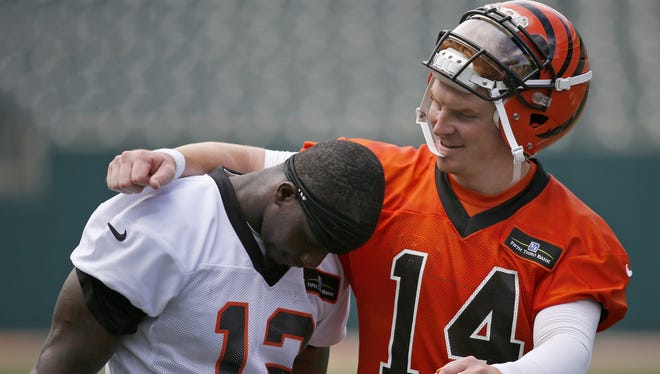 Cincinnati Bengals wide receiver Mohamed Sanu gets a hug from quarterback Andy Dalton. Sanu became a father on Friday. Dalton welcome his son last year.
