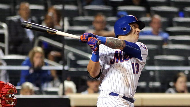 New York Mets shortstop Asdrubal Cabrera (13) hits a walk-off three-run home run in the bottom of the 11th inning in Thursday night’s game against the Philadelphia Phillies at New York’s Citi Field. The Mets won 9-8.