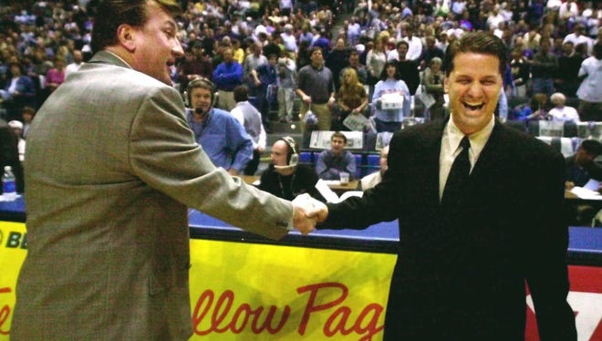 Then-Memphis head coach John Calipari, right, shakes hands with then-Cincinnati head coach Bob Huggins in February of 2001.