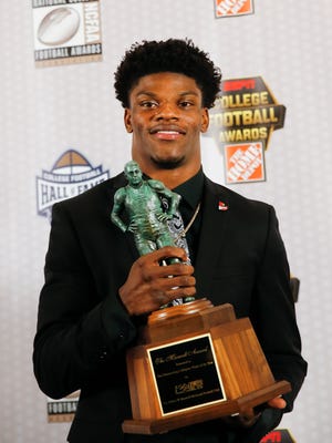 Louisville quarterback Lamar Jackson poses with the Maxwell Award after being named the College Football Player of the Year Thursday, Dec. 8, 2016, in Atlanta.