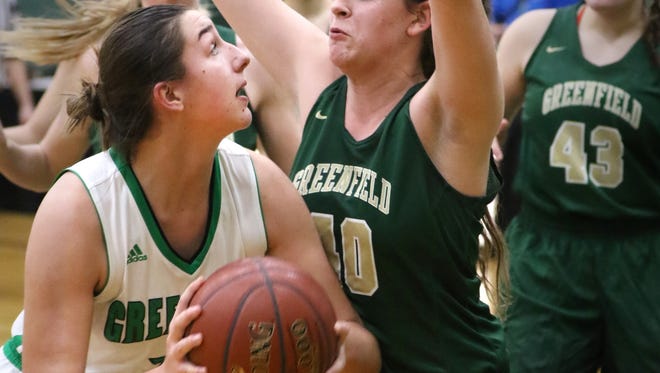 Greendale's Annie Pulizos sets for a basket beneath Greenfield defenders at Greendale on Dec. 22