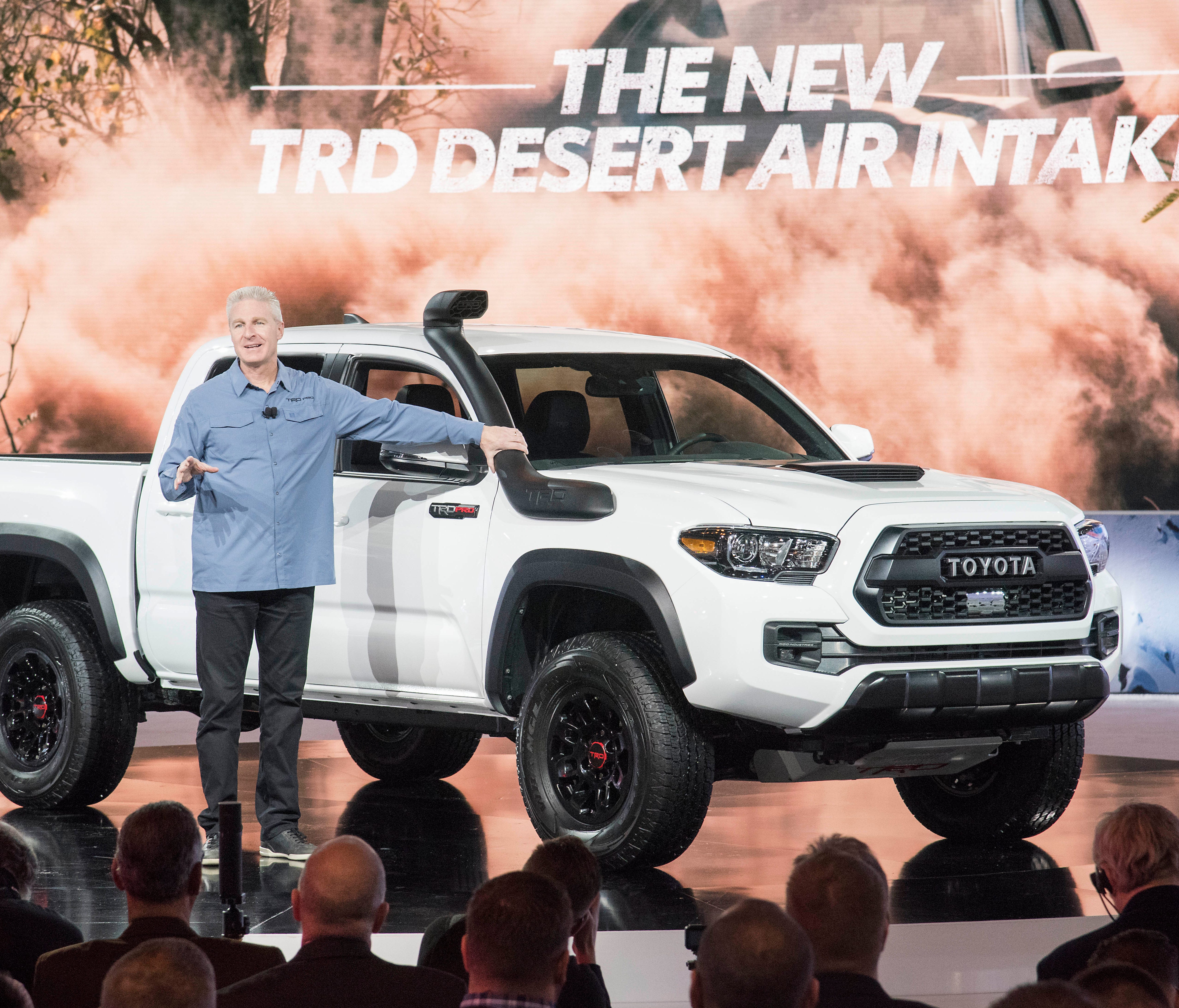 Toyota Division chief Jack Hollis shows off the snorkle breathing device on this truck at the Chicago Auto Show