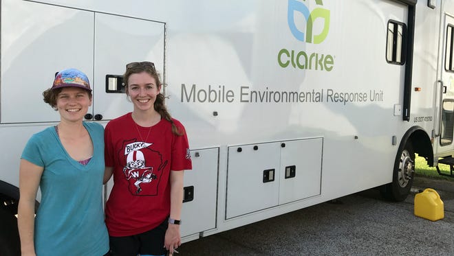 Melissa Farquhar (left) and Erin McGlynn, UWMadison professional students, stand outside the Clarke mobile entomology lab, where they are working to identify mosquitoes to assist mosquito-control efforts following Hurricane Harvey.