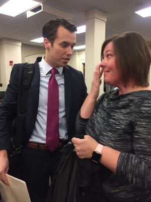 Jeanette McCue wiped away tears as she talked with Sen. Morgan McGarvey.