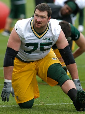 Green Bay Packers tackle Bryan Bulaga (75) stretches during organized team activities May 23, 2017, in Green Bay.