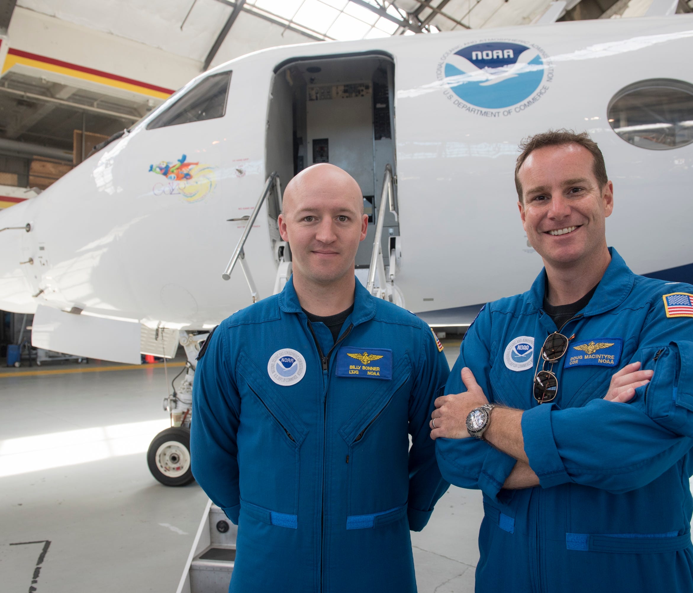 NOAA Aircraft Commander Doug Macintyre and Lt. Junior Grade Billy Bonner pose in front of 