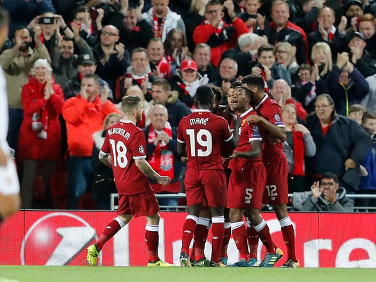 Liverpool's Roberto Firmino, third from right, celebrates with his teammates after scoring during the Champions League group E soccer match between Liverpool and Sevilla at Anfield stadium in Liverpool, England, Wednesday, Sept. 13, 2017. (AP Photo/Frank Augstein)