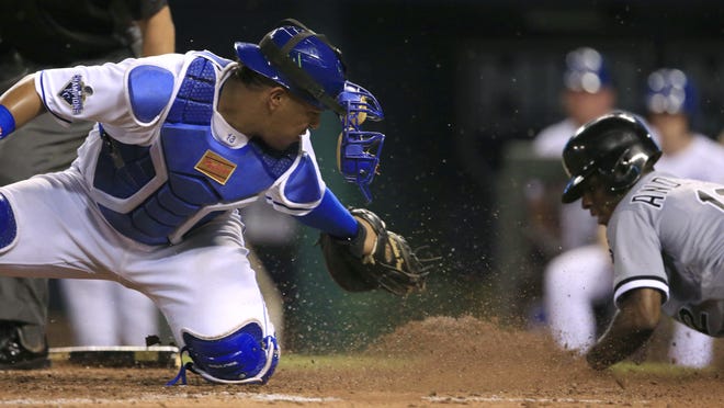 Royals catcher Salvador Perez, left, fails to tag Chicago's Tim Anderson (12) during the fifth inning. Anderson scored on a single by Melky Cabrera.
