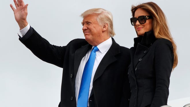 President-elect Donald Trump, accompanied by his wife Melania Trump, waves as they arrive at Andrews Air Force Base, Md., Thursday, Jan. 19, 2017, ahead of Friday's inauguration. (AP Photo/Evan Vucci)