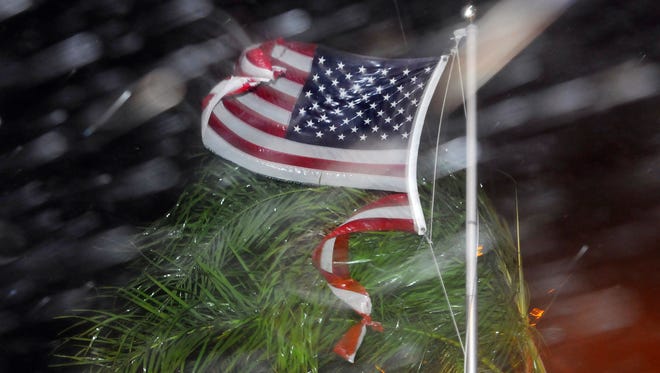 An American flag is ripped to shreds from heavy rain and wind from Hurricane Matthew early Friday, Oct. 7, 2016 in Cape Canaveral, Fla.   Matthew weakened slightly to a Category 3 storm with maximum sustained winds near 120 mph, but the U.S. National Hurricane Center says it's expected to remain a powerful hurricane as it moves closer to the coast.