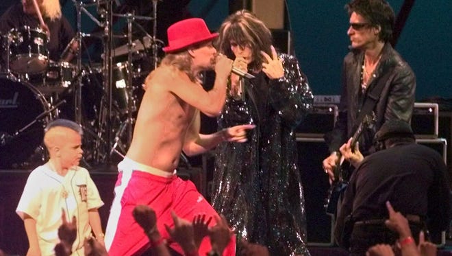 Kid Rock, center, and Joe C, left, perform during the 1999 MTV Video Awards in New York, Thursday, Sept. 9, 1999, with Aerosmith's Steven Tyler, center, and Joe Perry, right.