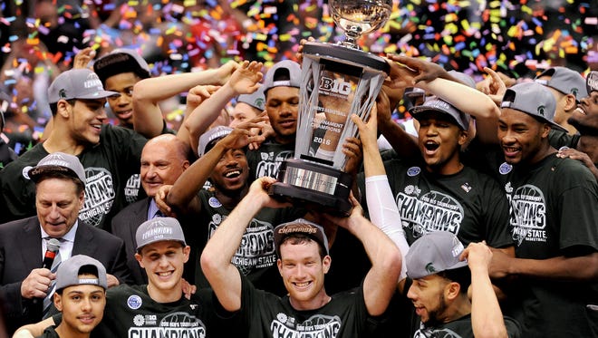 Michigan State senior forward Matt Costello (10) sticks his tongue out as the confetti falls and the team raises the Big Ten Championship trophy after MSU's 66-62 win over Purdue after the Big Ten Tournament Championship game, Sunday, March, 13, 2016 at Bankers Life Fieldhouse in Indianapolis. 