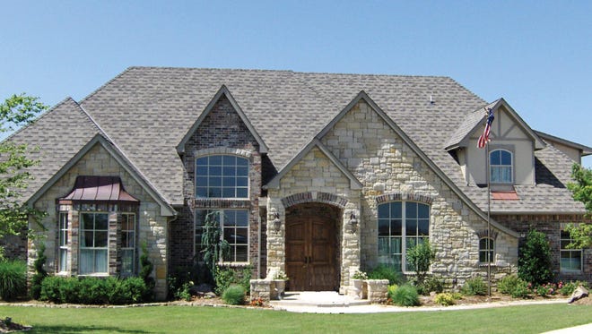 Talk about grand first impressions: stone, a bay window, and an arched entryway create impressive curb appeal for this home.