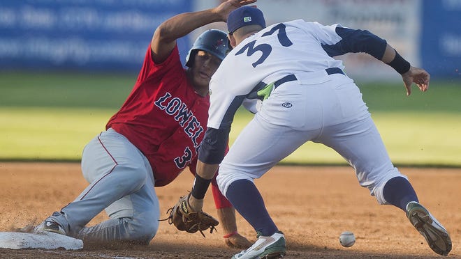 Lake Monsters' #37 Argenis Raga can't get the ball fast enough for a tag on Lowell's #3 Jeremy Rivera at third base during their home opener Friday night against Lowell at Centennial Field in Burlington.