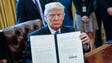 Trump displays one of five executive actions he signed