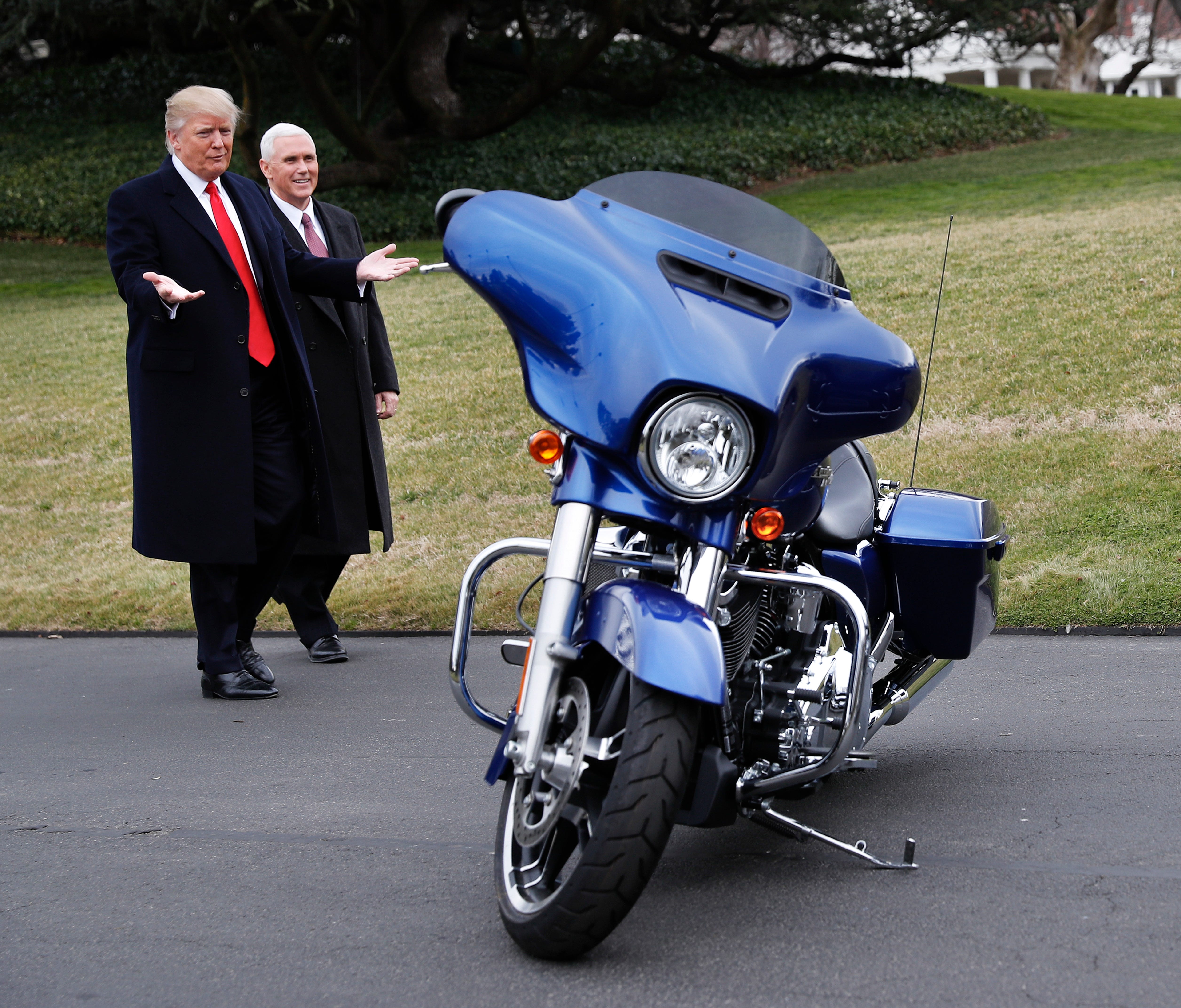 President Donald Trump and Vice President Mike Pence stop to admire a Harley Davidson motorcycle parked on the South Lawn of the White House on Feb. 2, 2017.