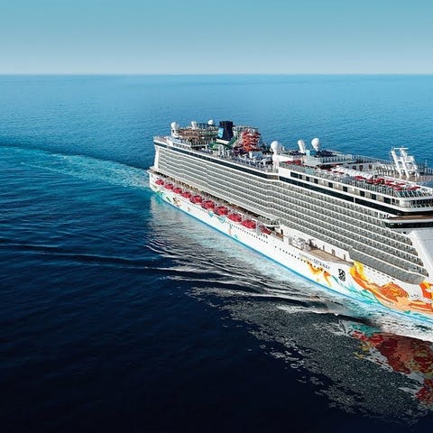 Cruise ship with colorful designs painted on side,