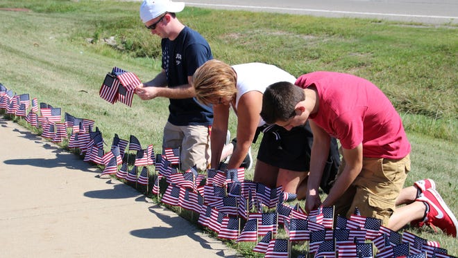 One by one, flags were planted by students and parents.