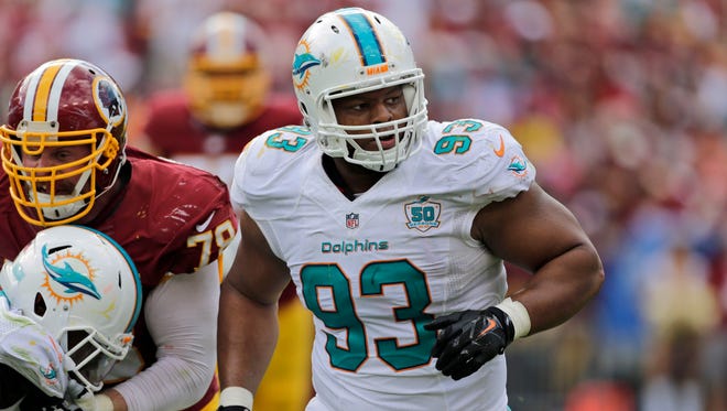 FILE - In this  Sunday, Sept. 13, 2015 file photo, Miami Dolphins defensive tackle Ndamukong Suh (93) rushes during the second half of an NFL football game against the Washington Redskins in Landover, Md.  Todd Bowles has figured out the key to slowing Ndamukong Suh, the disruptive and playmaking nose tackle of the Miami Dolphins. "Yeah," the New York Jets coach said with a smile, "him not playing." (AP Photo/Mark Tenally, File)