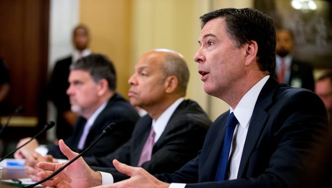 FBI Director James Comey, right, accompanied by Homeland Security Secretary Jeh Johnson, center, and National Counterterrorism Center Director Nicholas Rasmussen, left, testifies  on Capitol Hill in Washington, Wednesday, Oct. 21, 2015, before the House Homeland Security Committee hearing on worldwide threats and homeland security challenges.