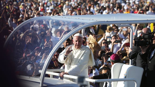 POPE MASS JUAREZ - Pope Francis rides in his Popemobile before placing flowers at three crosses at an altar close to the Rio Grande, where he then turned and blessed a group of about 600 VIP’s on the United States side of the Rio Grande Wednesday afternoon.
