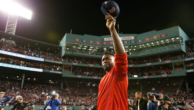 Boston Red Sox designated hitter David Ortiz (34) salutes the fans after losing to the Cleveland Indians in game three of the 2016 ALDS playoff baseball series at Fenway Park.