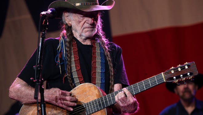 Willie Nelson plays his signature Martin guitar during a performance for 6,000 fans on Wednesday night at The Pavilion.