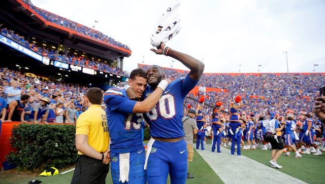 Florida Gators quarterback Feleipe Franks and tight end C'yontai Lewis congratulate each other after beating the Tennessee Volunteers.
