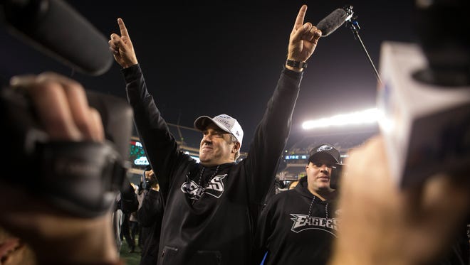Philadelphia Eagles head coach Doug Pederson raises his hands to the fans as he heads into the tunnel after defeating the Minnesota Vikings in the NFC Championship 38-7 on Jan. 21, 2018.