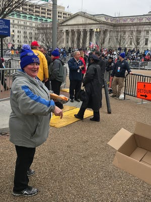 Jenny Bultman passes out food and other good to people at the inaugural parade immediately following the swearing-in ceremony.