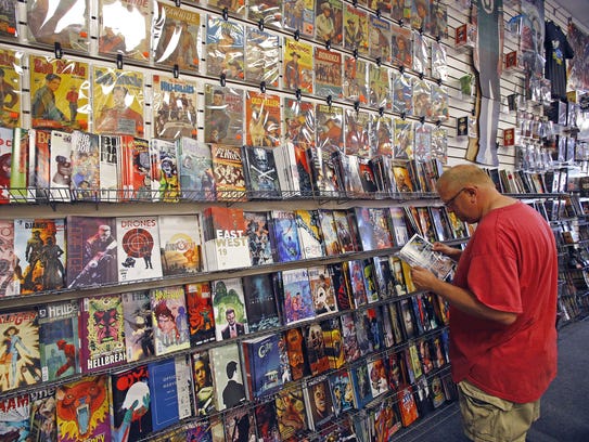 John Hancock checks out the comic-book selection on