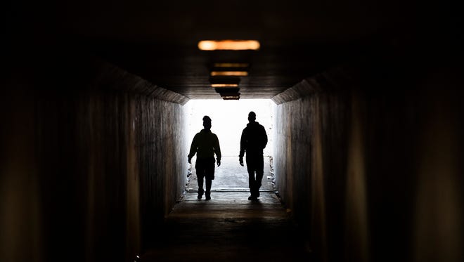 Two Lee High School students walk through the tunnel running under Atlanta Highway between Lee High School and Capitol Heights Middle School on Tuesday, Dec. 8, 2015. 