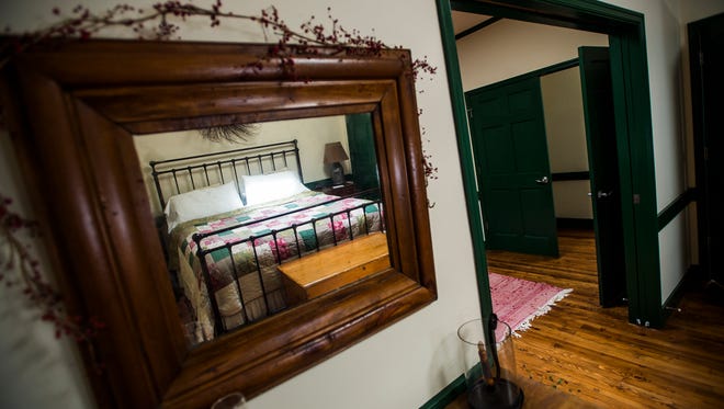 The bed is reflected in a wall mirror inside one of the large first floor suites of the Brafferton Inn on York Street in Gettysburg.