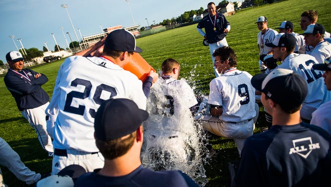 Dallastown's Riley Hamberger (29) dumps the cooler on fellow player Brandon White (19) after Dallastown won the YAIAA baseball championship against Northeastern on Tuesday May 17, 2016 at New Oxford High School.