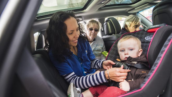 Health educator with WellSpan Gettysburg, Yeimi Gagliardi, tests the harness in the car seat of one year-old Henry Fox of Gettysburg in 2015 at the Gettysburg WellSpan. Grandparents Joan and Bill Fox brought their car seat to be inspected by Gagliardi, who's a certified passenger safety technician.