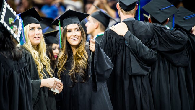 Students line up and wait for their names to be called during the commencement of the Fall 2016 class of FGCU at Alico Arena in Fort Myers, Fla., on Sunday, Dec. 11, 2016. FGCU has awarded more than 23,000 degrees since fall 1997.