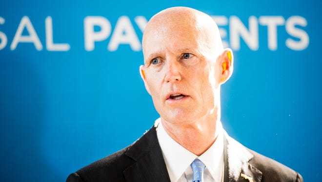 Gov. Rick Scott talks at a press conference about job growth at ACI Worldwide in Naples, Fla., on Monday, Dec. 12, 2016. Scott made a visit to ACI Worldwide, an IT company that powers electronic payments for financial institutions, retailers and processors around the world to talk about Florida's economy.