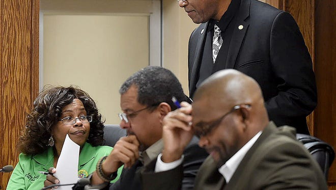 Opelousas Mayor Reggie Tatum confers with Opelousas City Clerk Leisa Anderson prior to the start of Tuesday’s regular meeting of the board of aldermen. Also pictured are Aldermen Tyrone Glover, seated center, and Julius Alsandor.