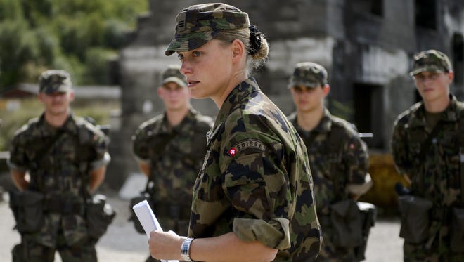 A captain of the rescue troops of the Swiss Army stands with aspirant-officiers on Thursday in Epeisse near Geneva.
