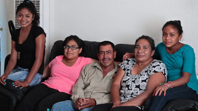 From left, Carla Gonsalez, Margarita Gonsalez, Gonsalo Solis, Maria Gonsalez and Christina Gonsalez sit in their new home in Desert Hot Springs. Community donations put them in a house after a fire destroyed their trailer home last month.