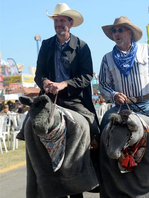 Tom Kisken, left, a Ventura County Star reporter, and Bob McMeans, who performs as Slim, wear horse-riding costumes to entertain the crowds at the Ventura County Fair.
