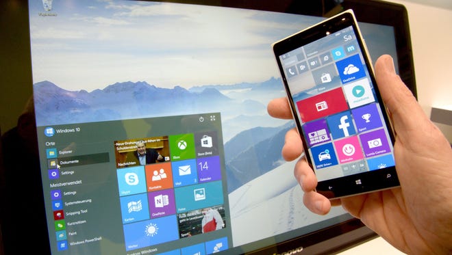 A user demonstrates the look and feel of Windows 10 operating system for smartphones and at the Microsoft stall at the CeBIT technology fair in Hanover, Germany.