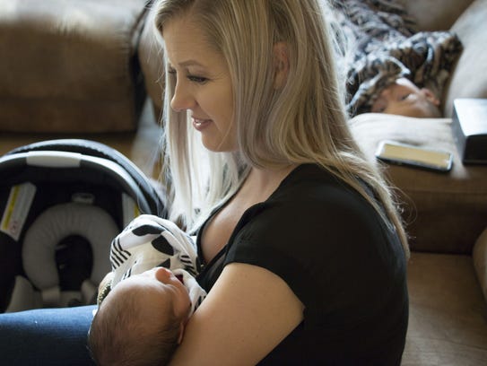 Shannon Geise holds her newborn son, Sebastian, while