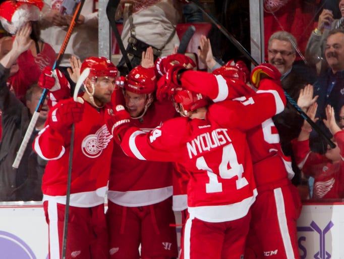 The Red Wings celebrate the winning goal by Justin