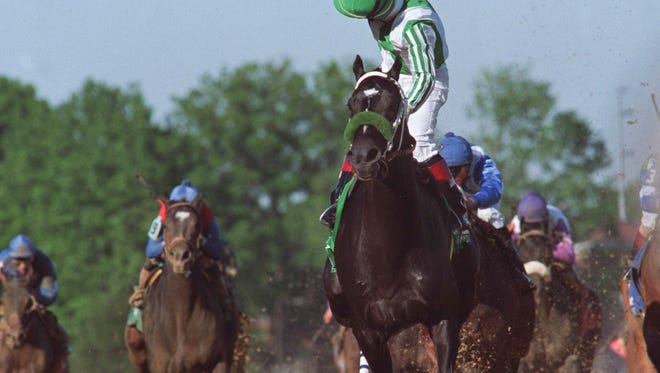 Winning jockey Victor Espinoza reacted after crossing the finish line on War Emblem. The colt became the only horse sold after his final prep to win the Derby in modern times.