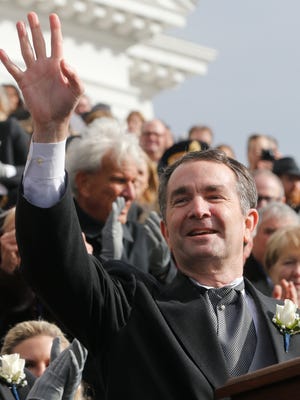 Gov. Ralph Northam waves to the crowd after taking the oath of office during inaugural ceremonies at the Capitol in Richmond, Va., Saturday, Jan. 13, 2018.