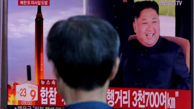 A man watches a TV screen showing a file footage of North Korea's missile launch and North Korean leader Kim Jong Un, at the Seoul Railway Station in Seoul, South Korea, Friday, Sept. 15, 2017. South Korea's military said North Korea fired an unidentified missile Friday from its capital Pyongyang that flew over Japan before landing in the northern Pacific Ocean. The signs read "South Korea's Joint Chiefs of Staff said the missile traveled about 3,700 kilometers."