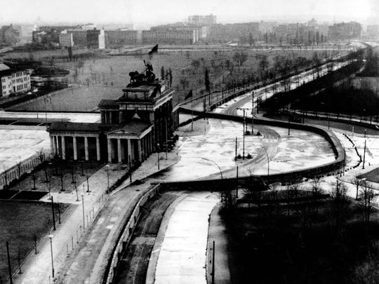 The Brandenburg Gate is sealed off in the Soviet-occupied sector of East Berlin, Germany, in November 1961. Located at the center of the German capital, the gate stands behind part of the Berlin Wall that divides East and West Berlin.