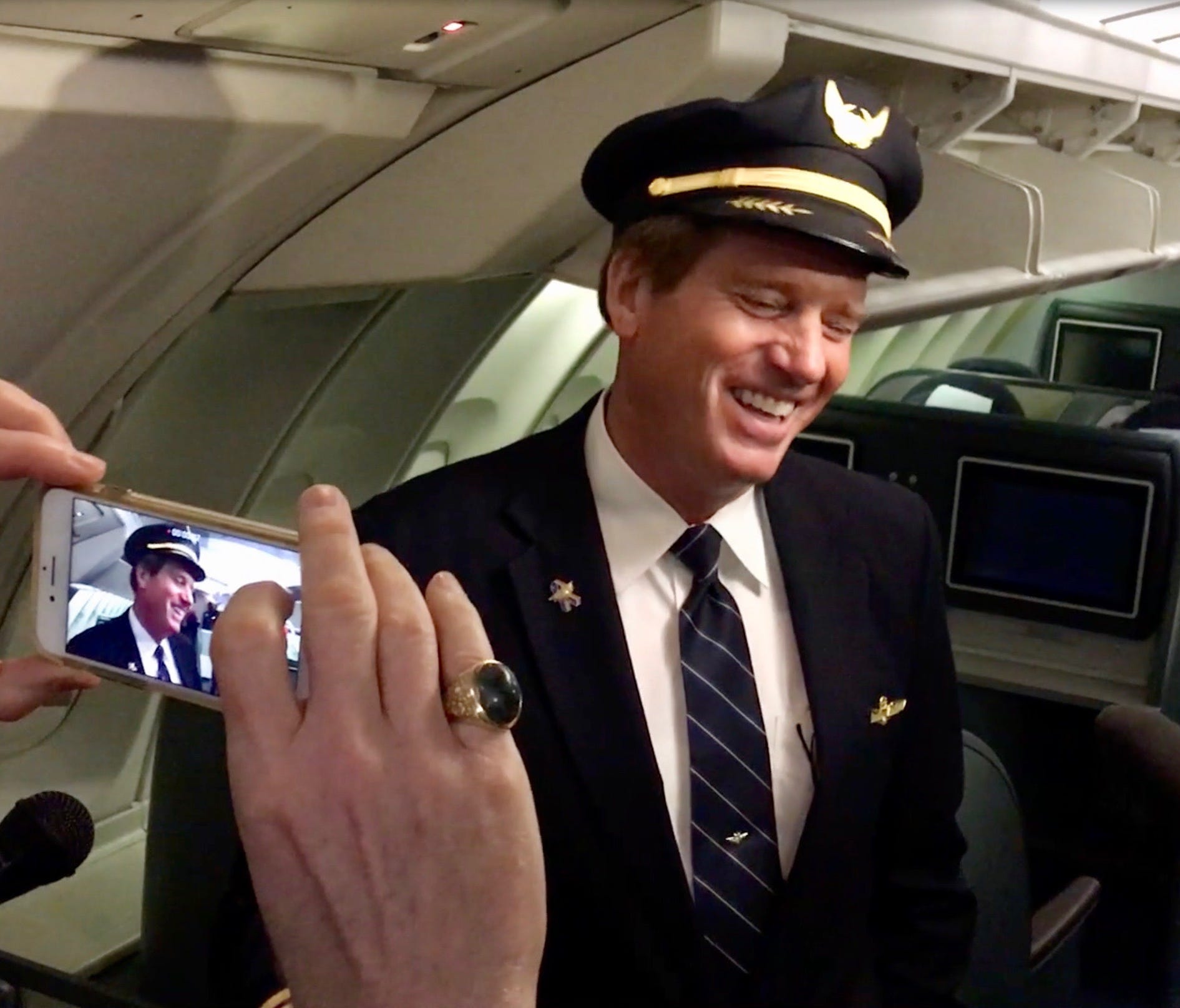 United Airlines Captain David Smith laughs during an interview aboard Flight 2704 Friday at Chicago O'Hare International Airport.